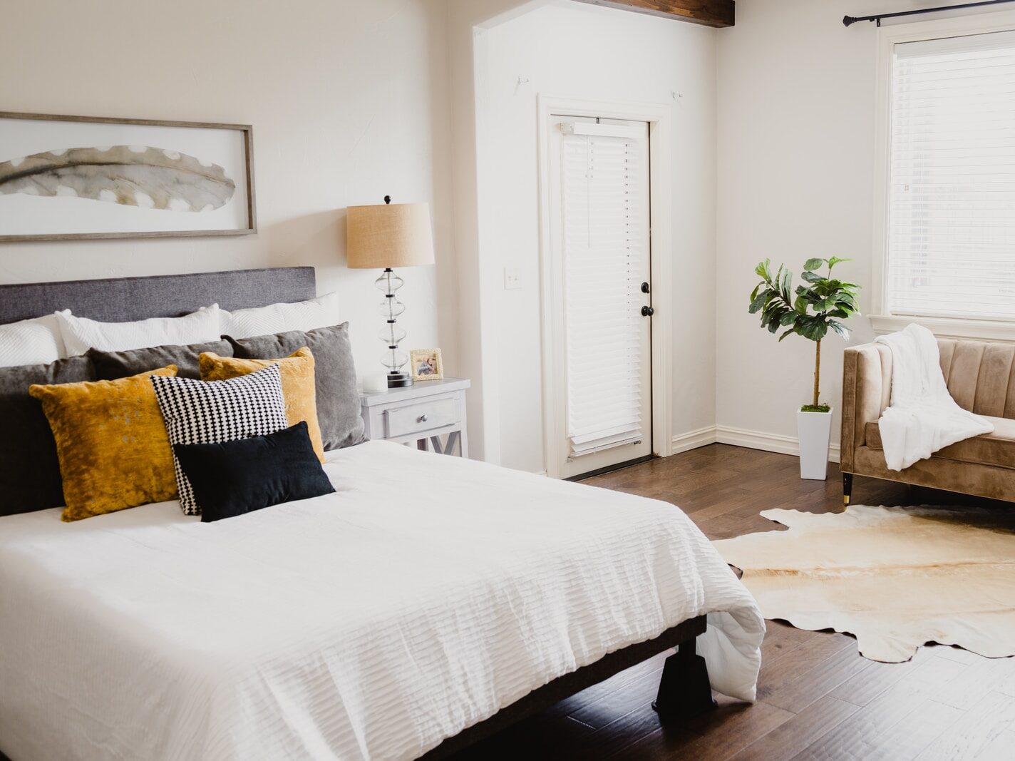 white bed linen near white wooden door