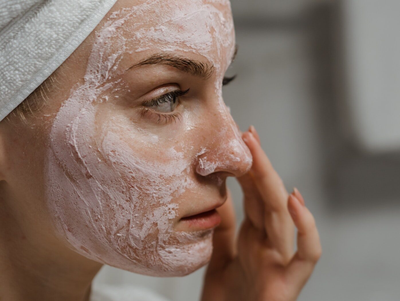 Close-up Photo of a Woman Applying Facial Cream