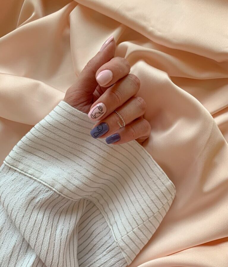 A Hand With Manicured Nails on White Textile