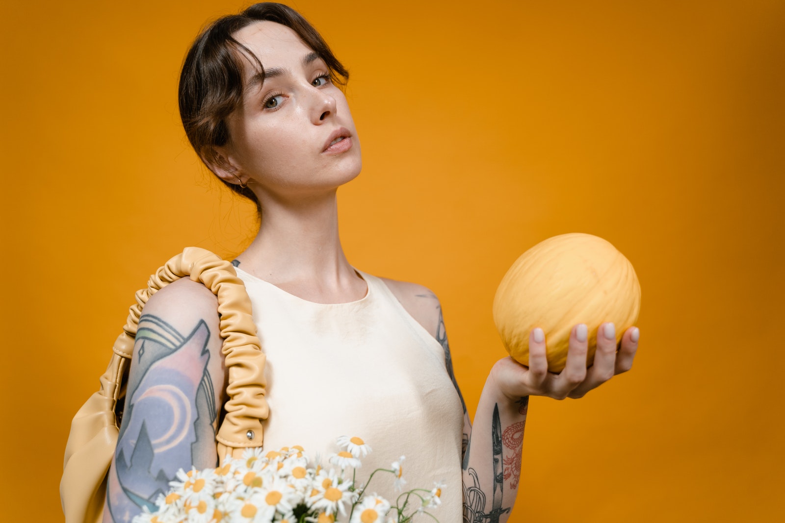 Close-up Photo of Woman holding a Yellow Melon