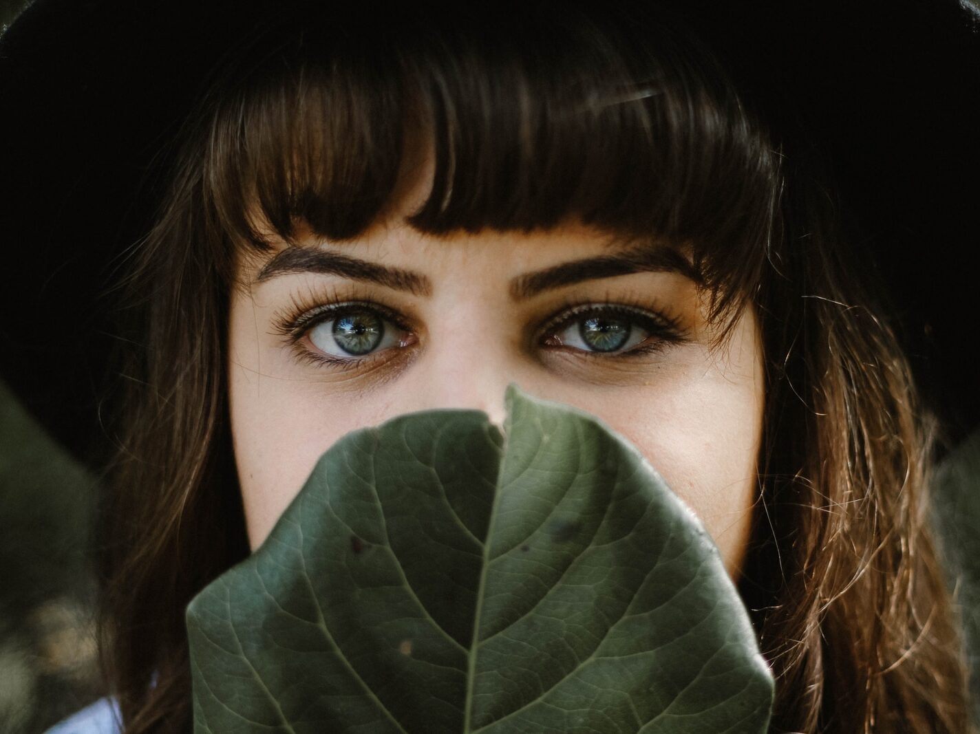 women beside green leaf