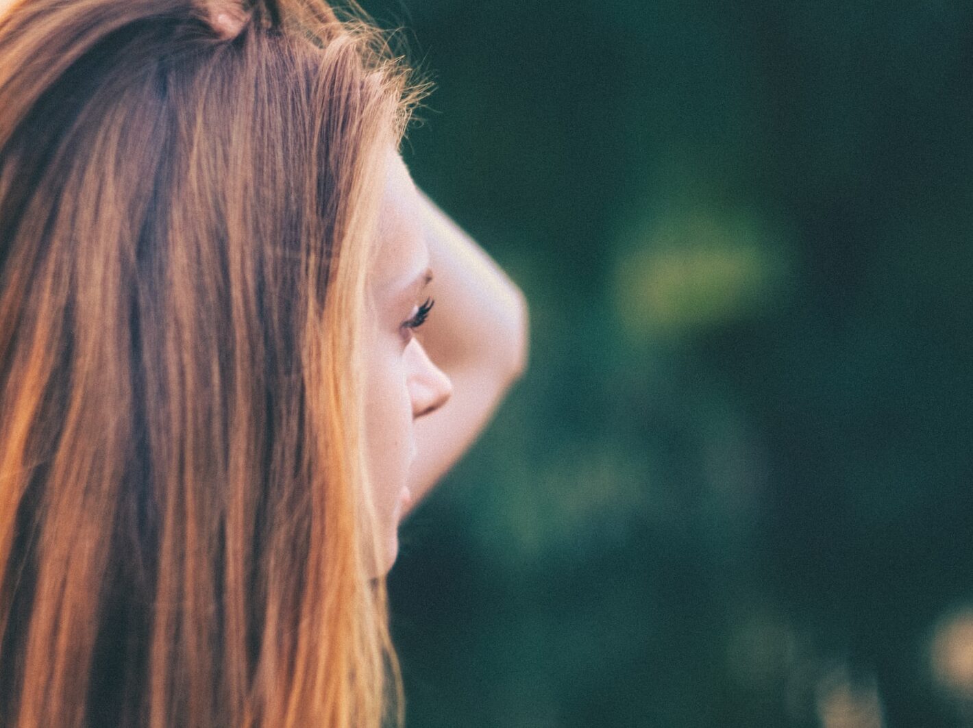 selective focus of woman holding her head at daytime