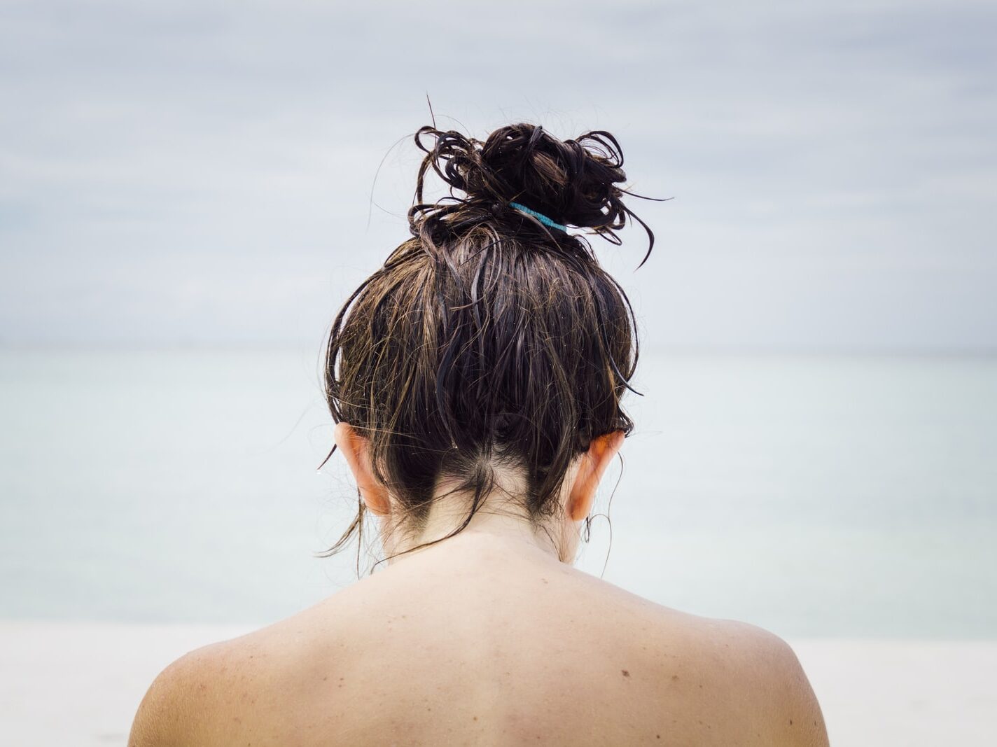 woman facing seashore
