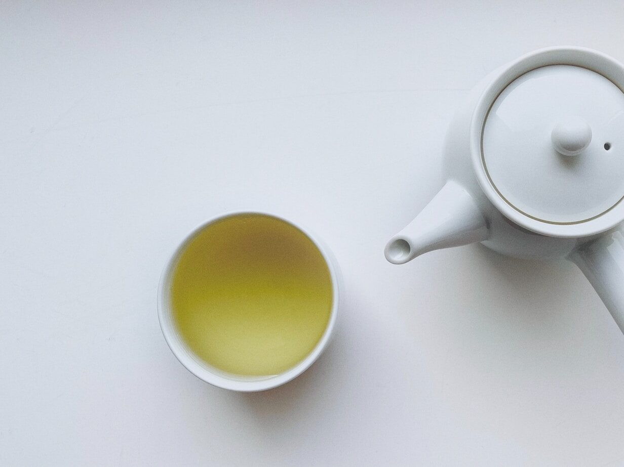 white ceramic teapot beside white ceramic mug