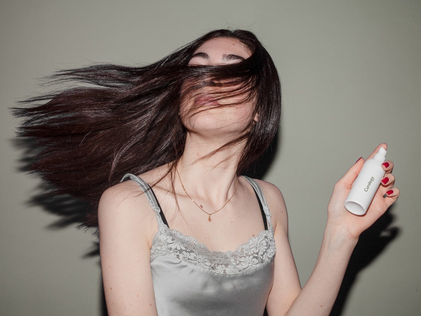 woman holding spray bottle