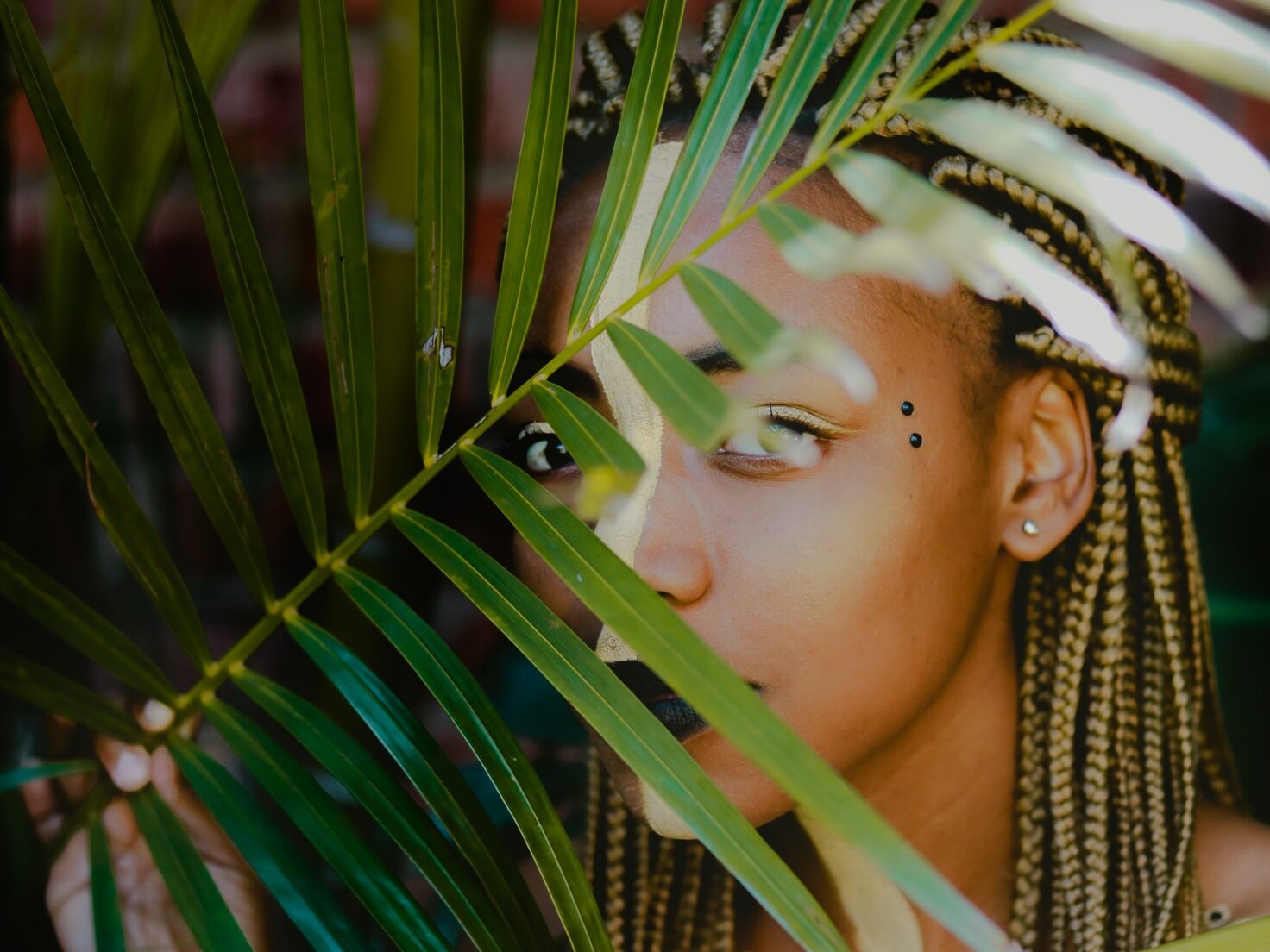 woman holding green leaf