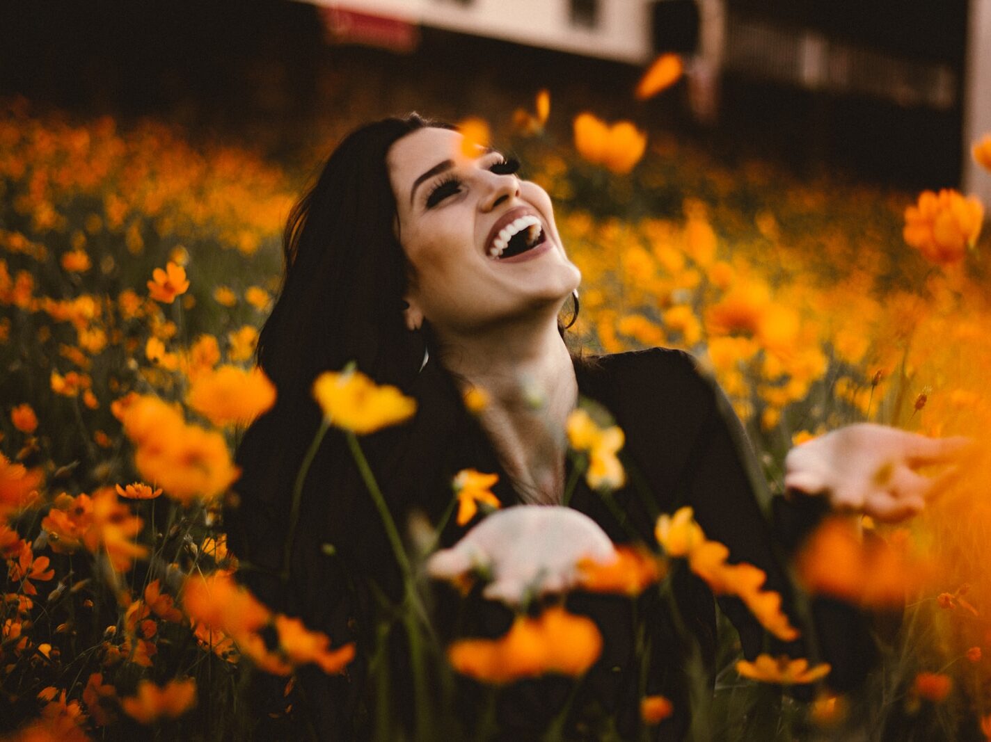 woman laughing on flower field