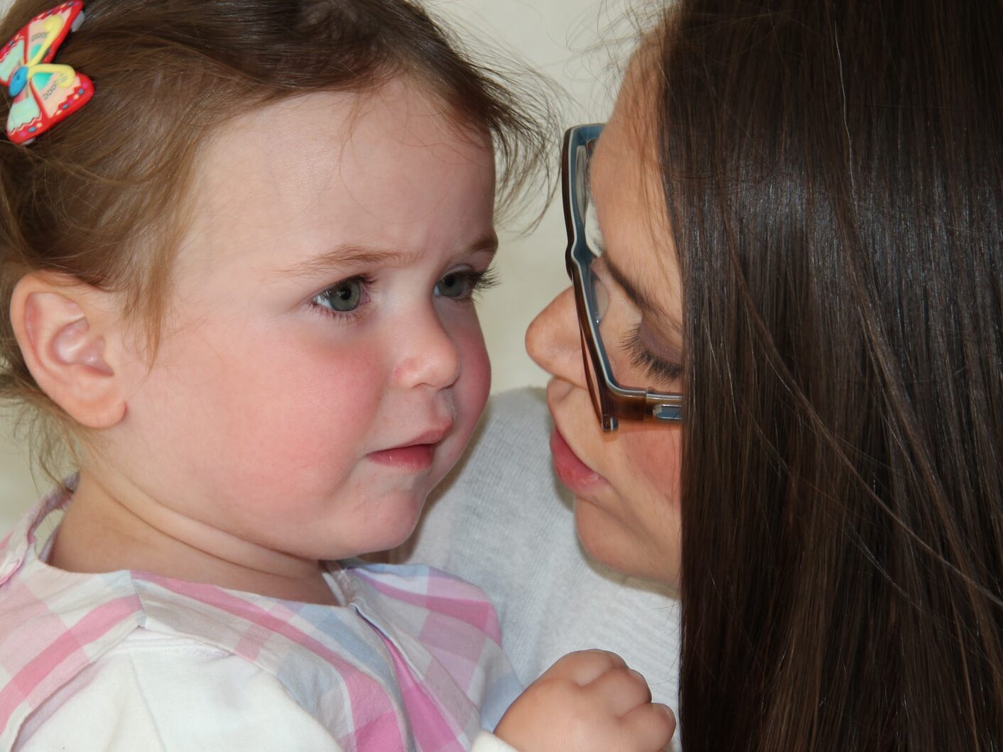 girl in white and pink stripe shirt wearing eyeglasses
