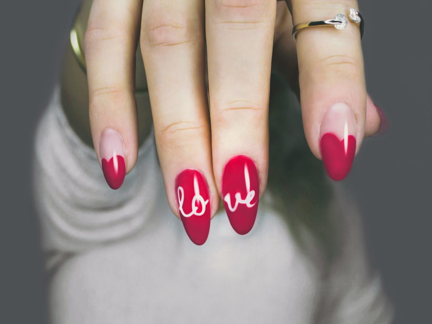 selective focus photography of woman's pink manicure