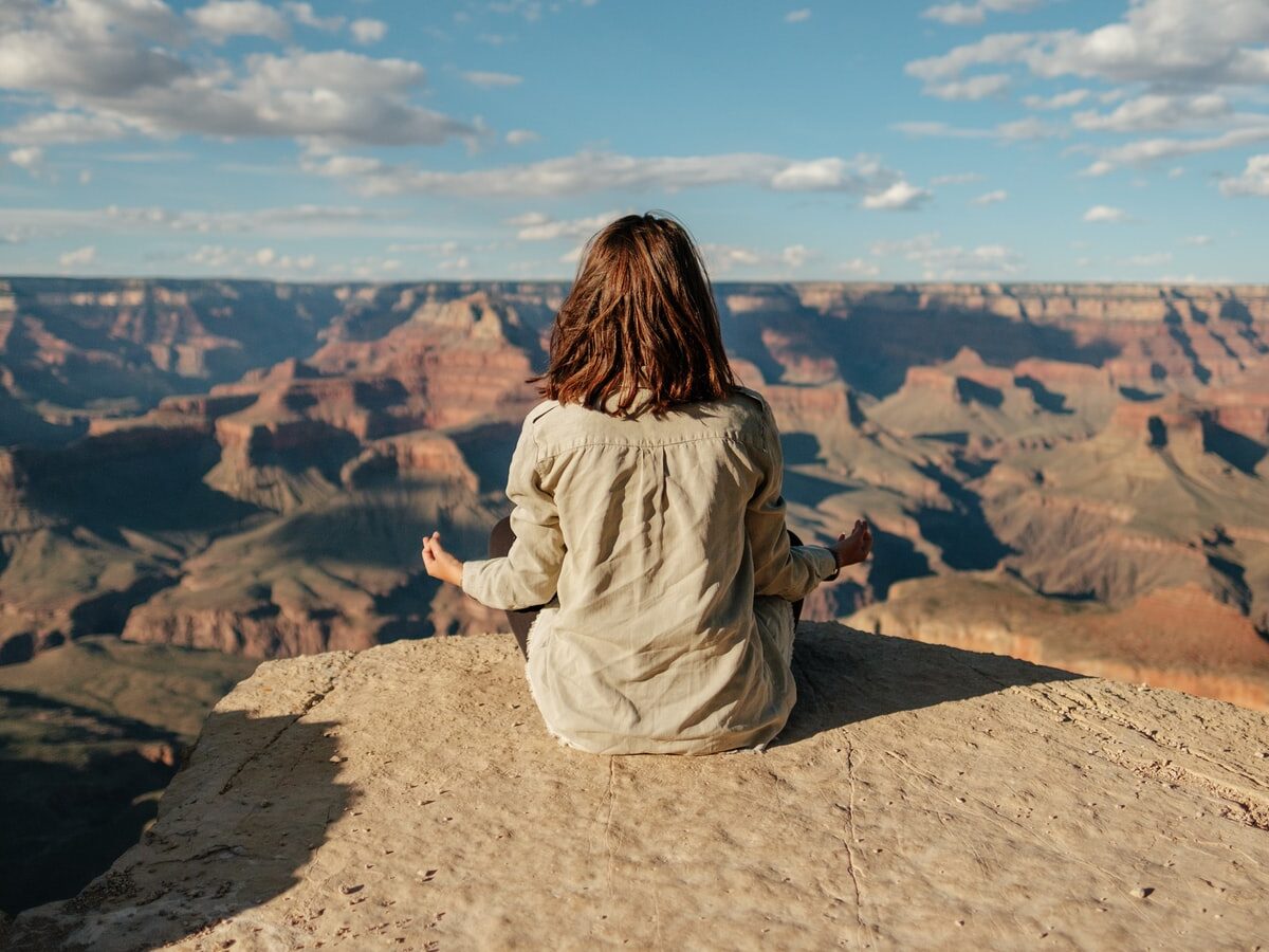 woman sitting on hill
