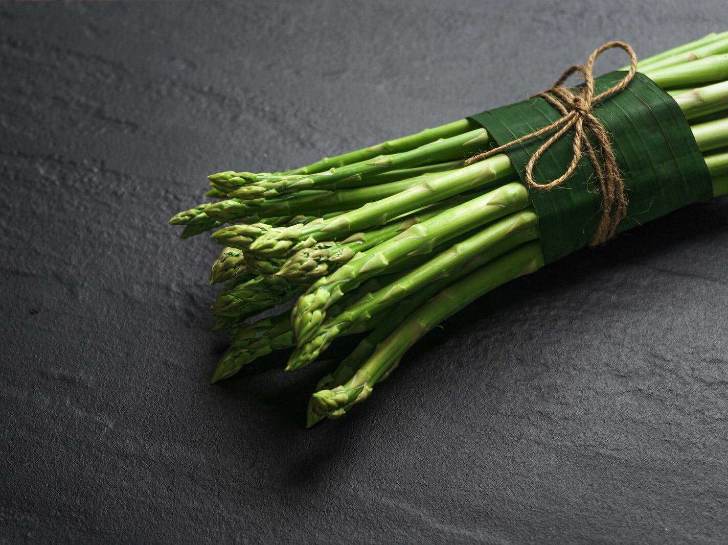 green vegetable on black textile