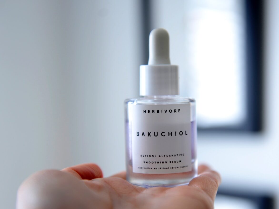 person holding white plastic bottle