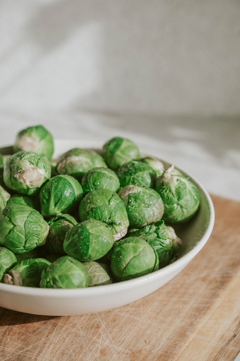 green vegetable on white ceramic bowl