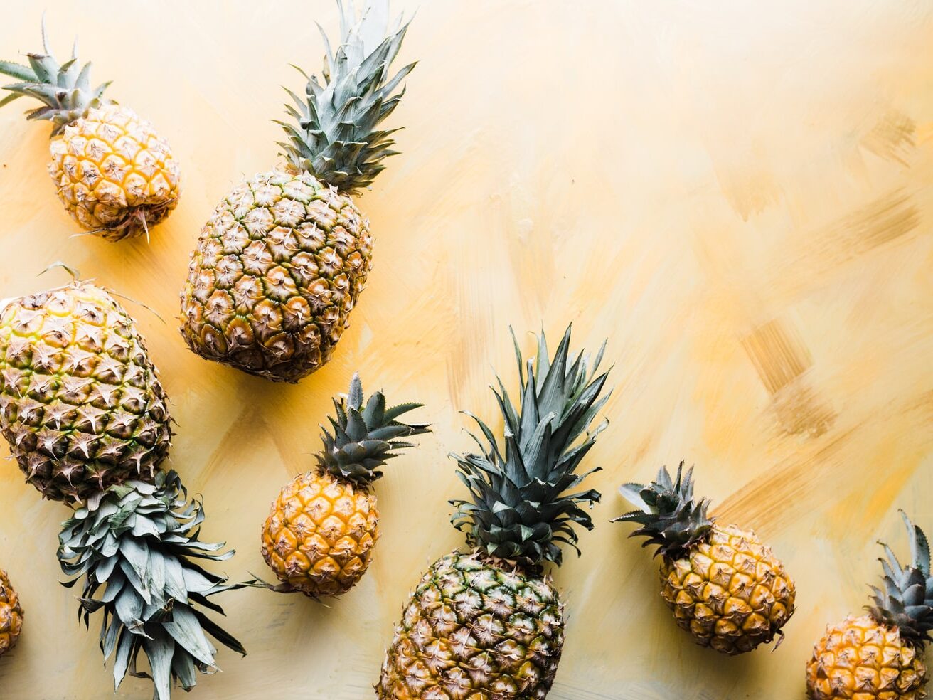pineapples on brown surface