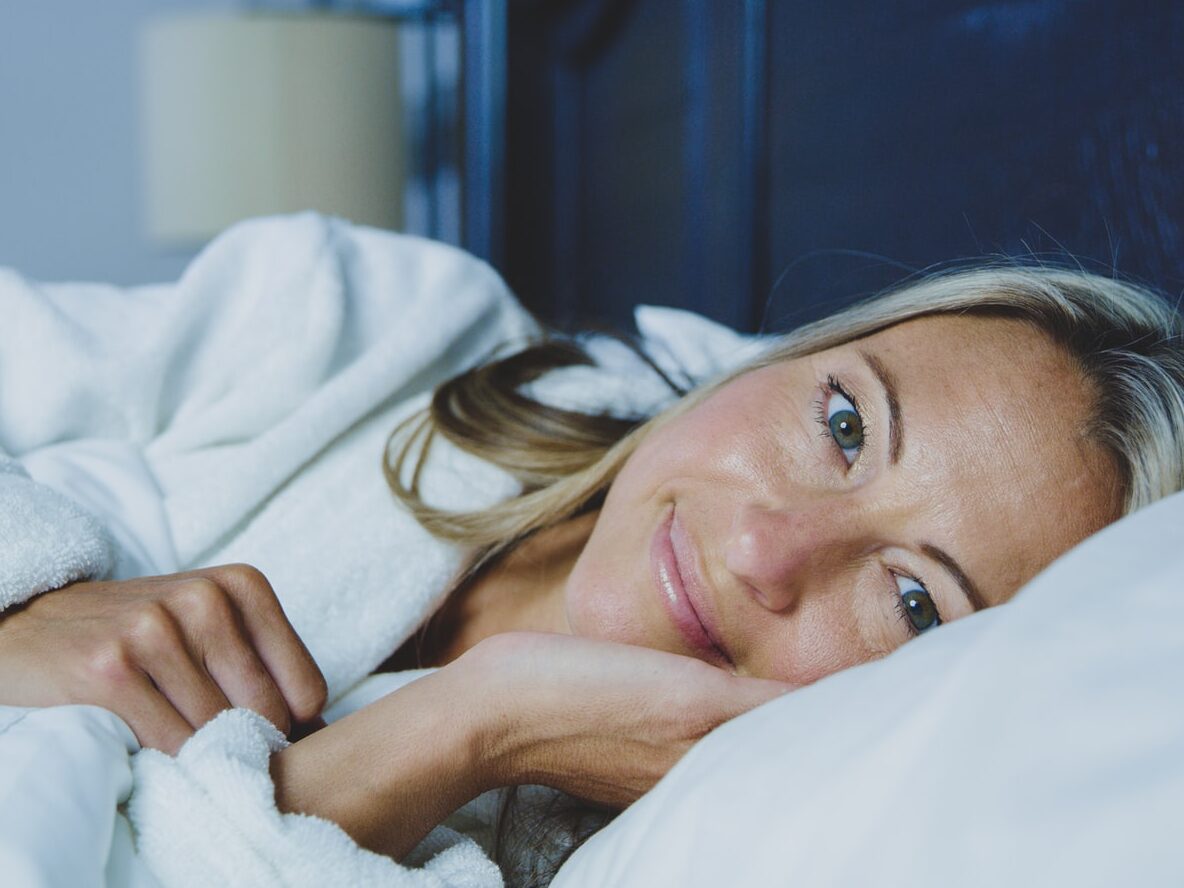 woman lying on bed
