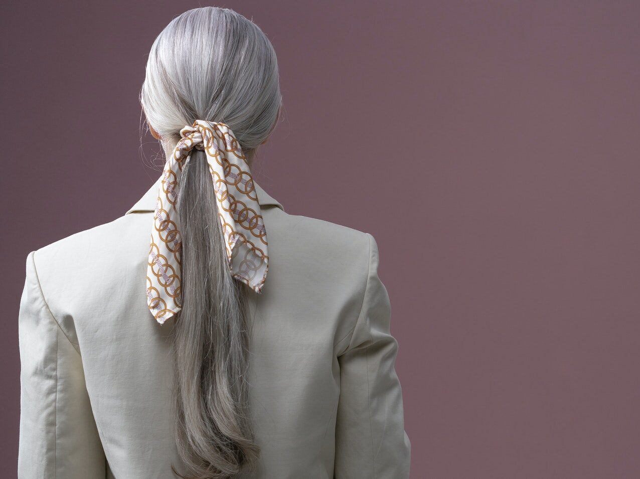Woman in Gray Blazer With Blue and Orange Floral Headband