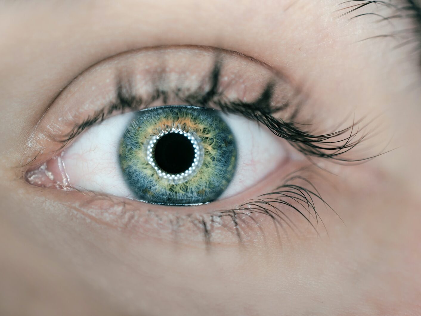 person showing green and black eyelid closeup photography