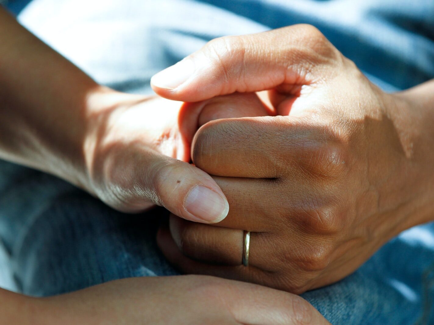 person wearing gold wedding band