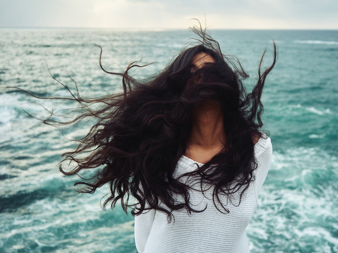 woman standing near body of water during daytime