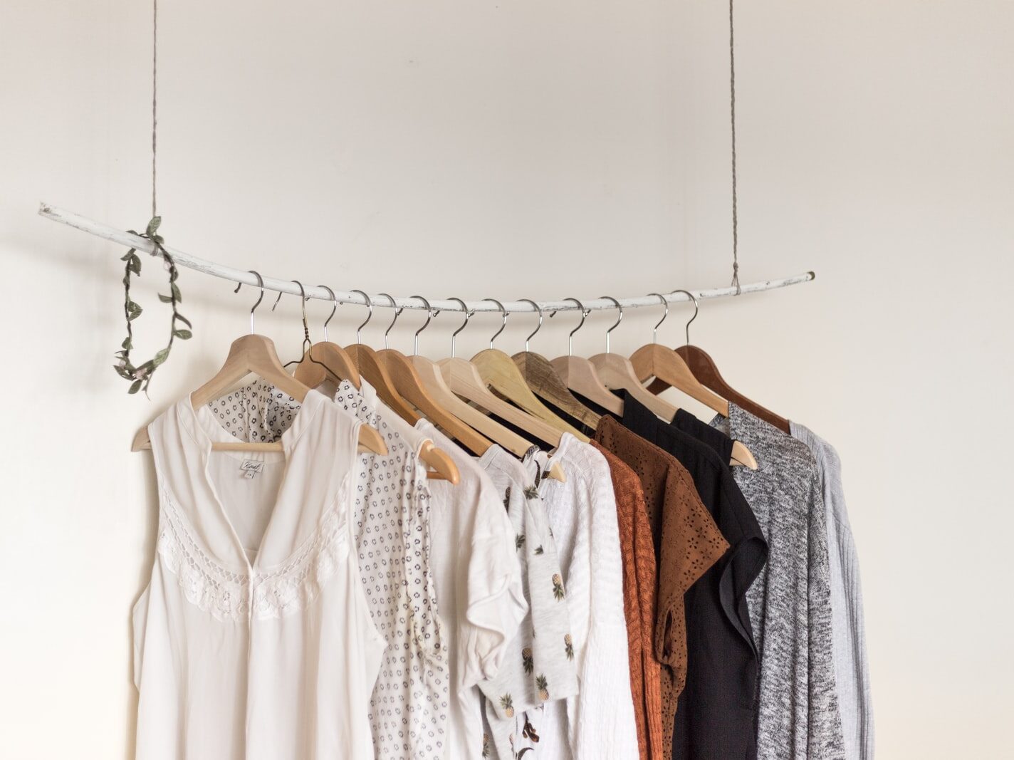 assorted clothes in wooden hangers
