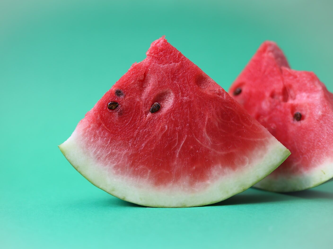sliced watermelon on green surface