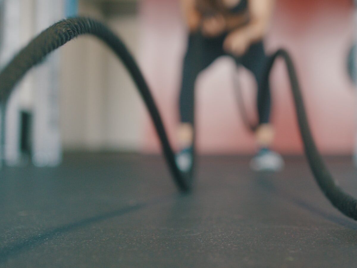 person holding black exercise rope