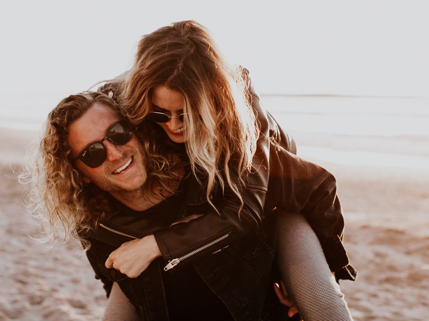 woman in black leather jacket wearing black sunglasses