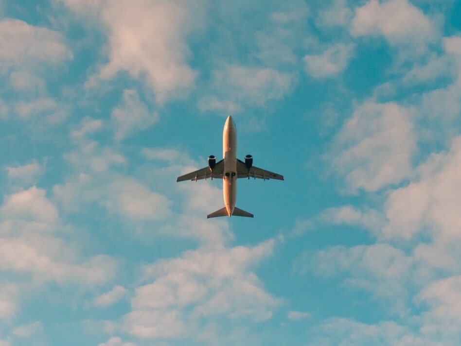 white airplane flying in the sky during daytime