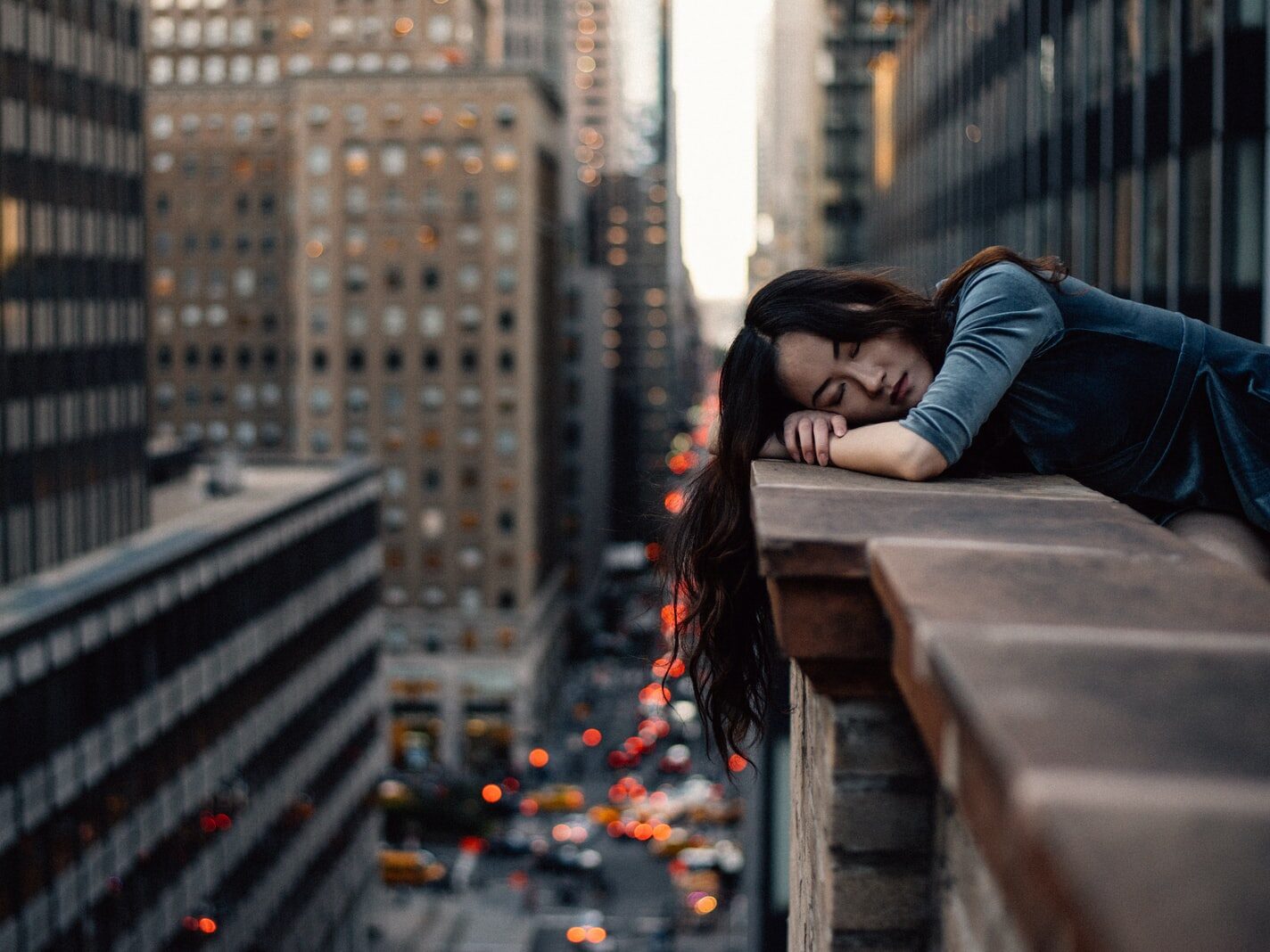 woman leaning on top building rail during daytime
