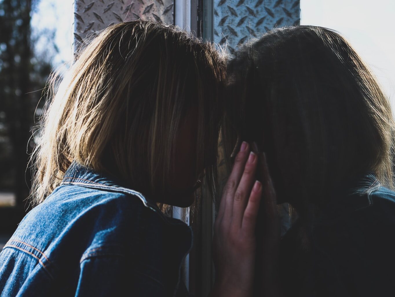 woman standing in front of mirror
