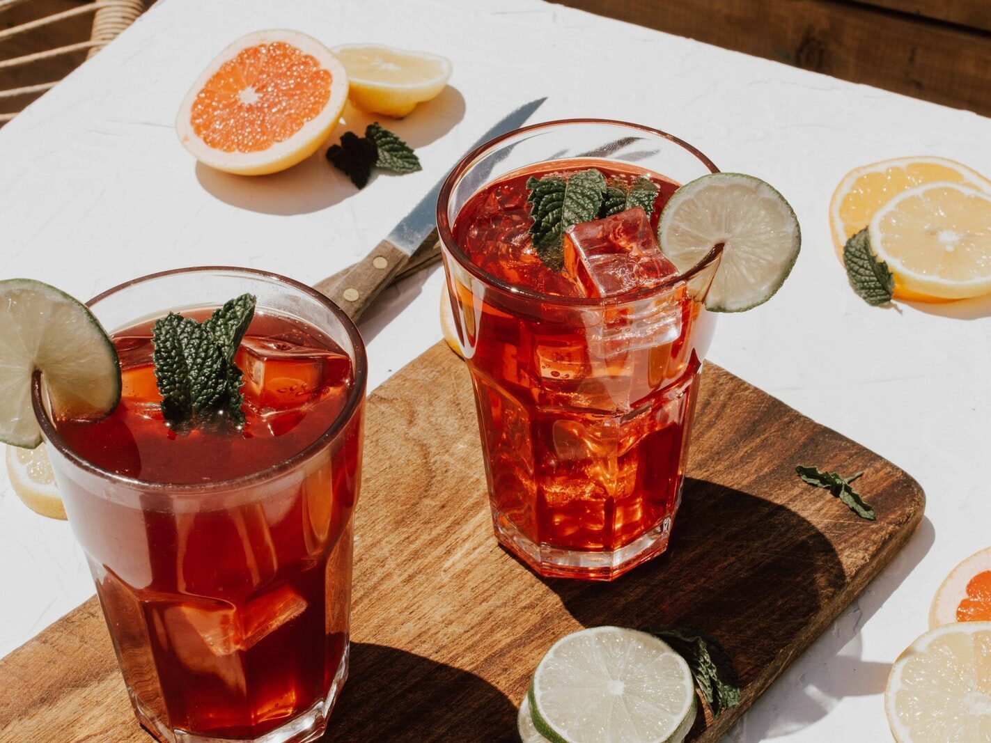 two clear drinking glasses with filled red liquid