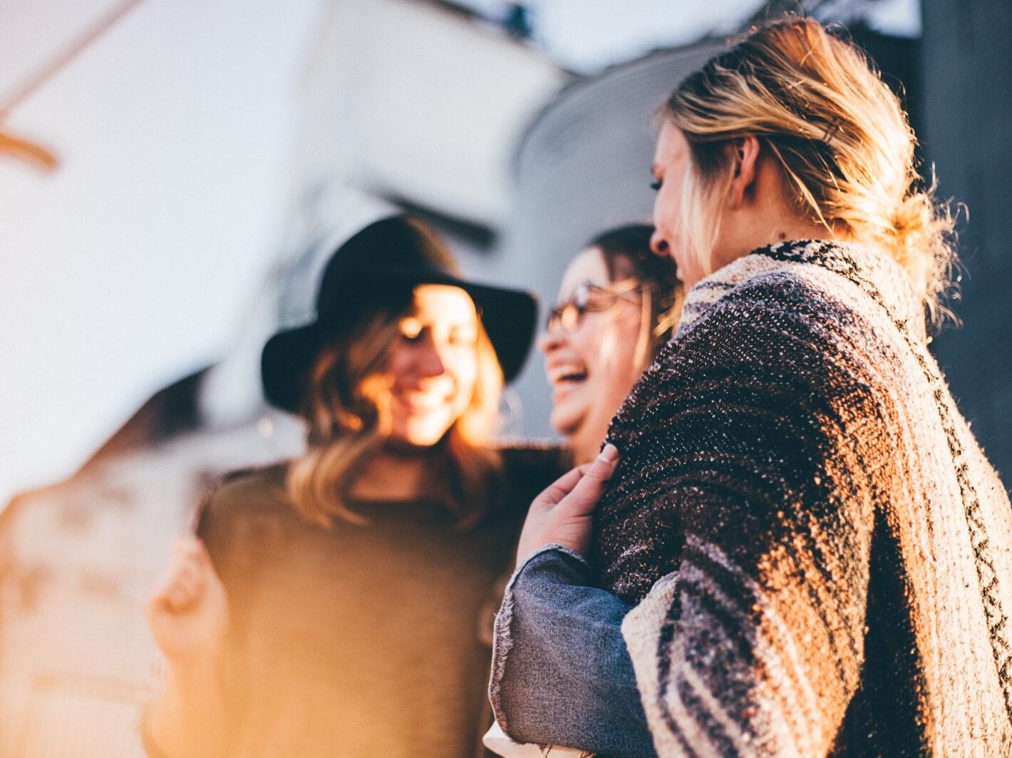 people laughing and talking outside during daytime