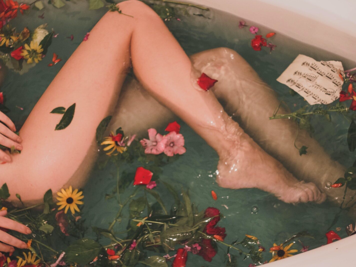 bathtub with water and flowers