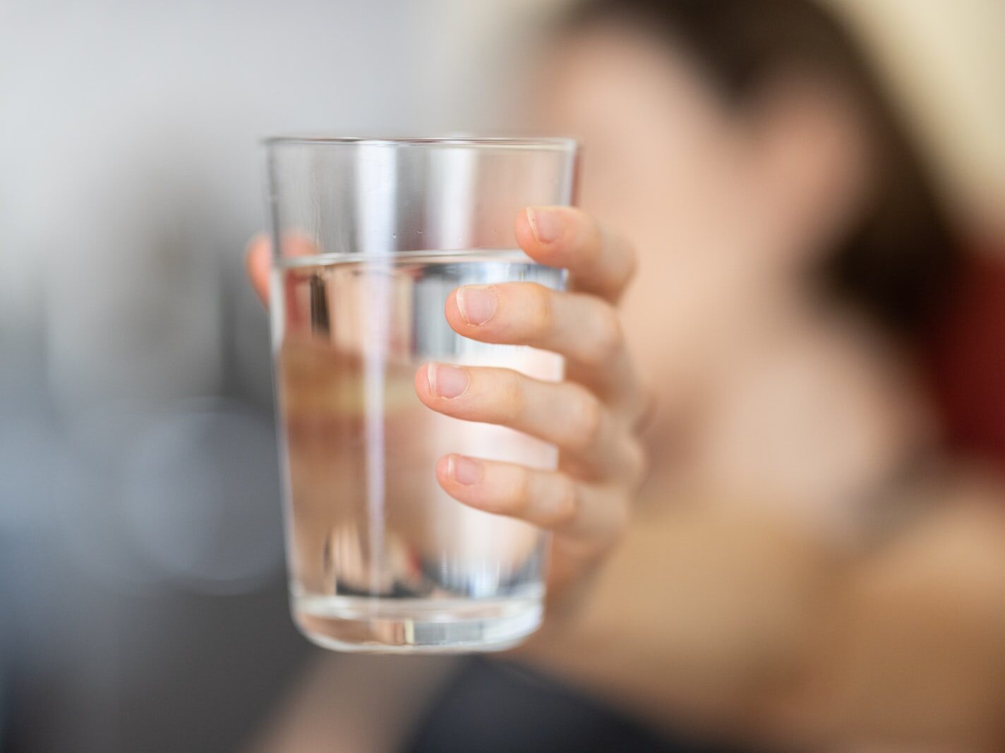 person holding clear drinking glass