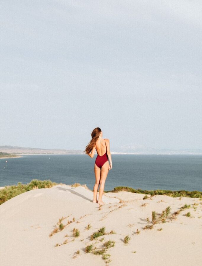 woman standing near mountain cliff