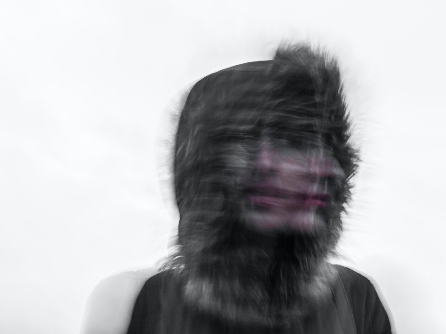 Creepy blurred photo of a person's face and a furry hood