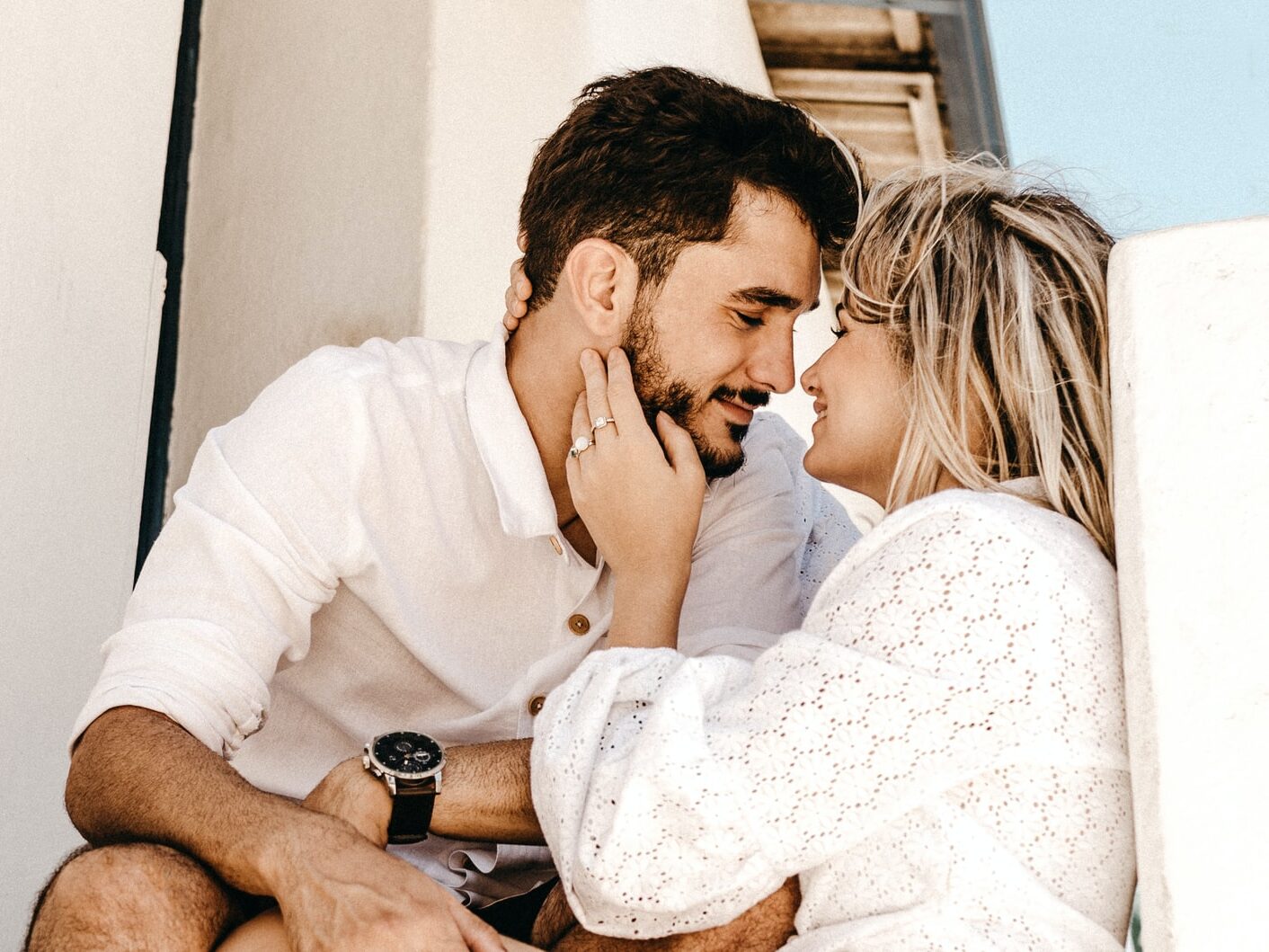 smiling man and woman about to kiss