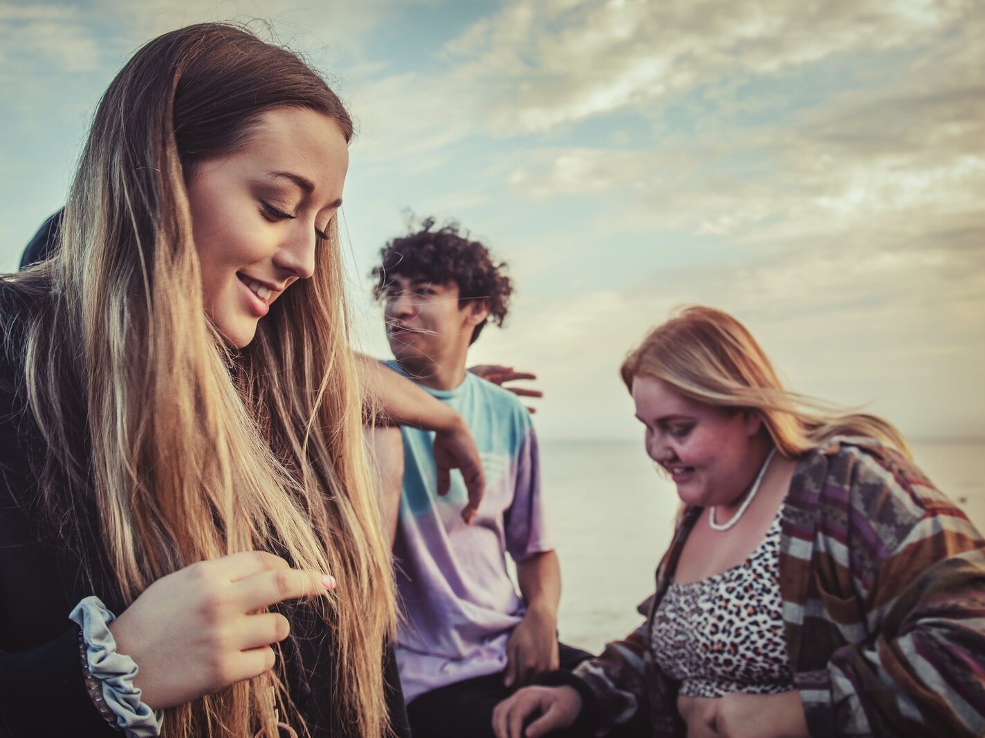 women and man near body of water