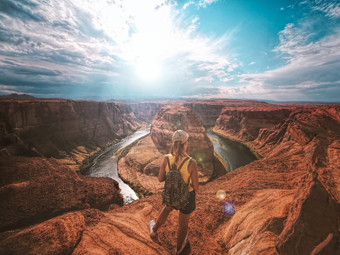 woman standing on top of canyon
