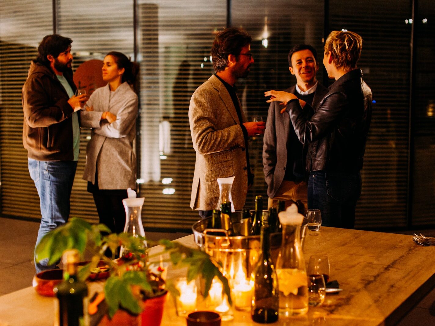 five person standing while talking each other