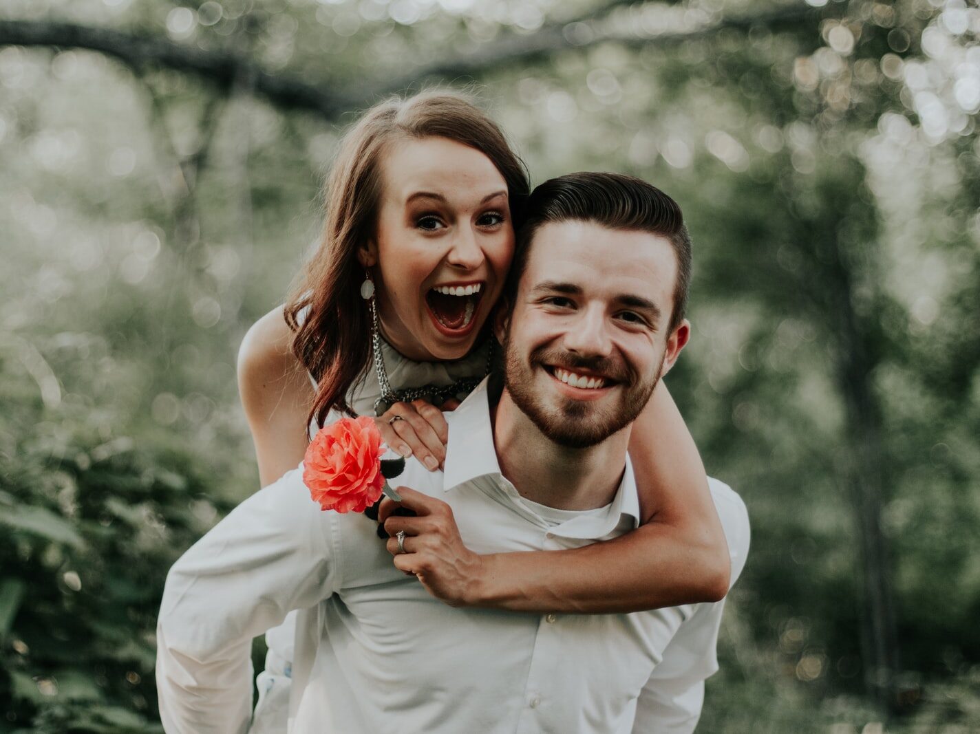 woman riding on back of man