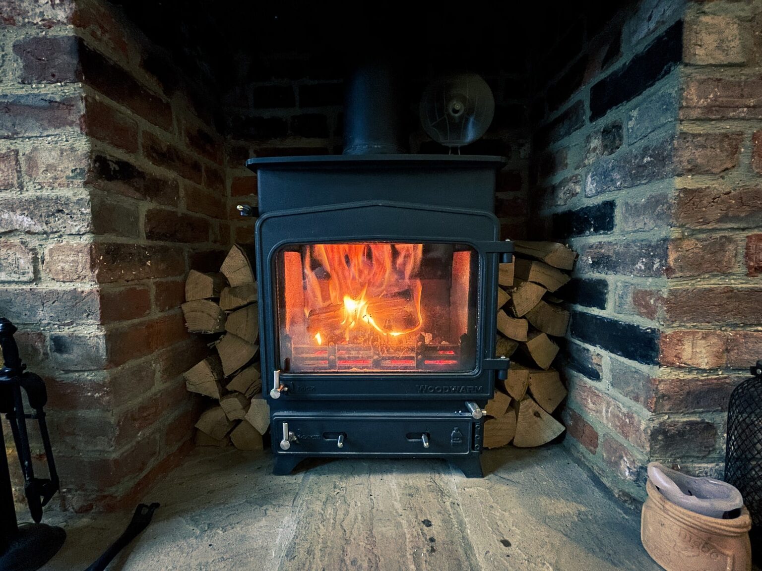 black wood burner near brown brick wall