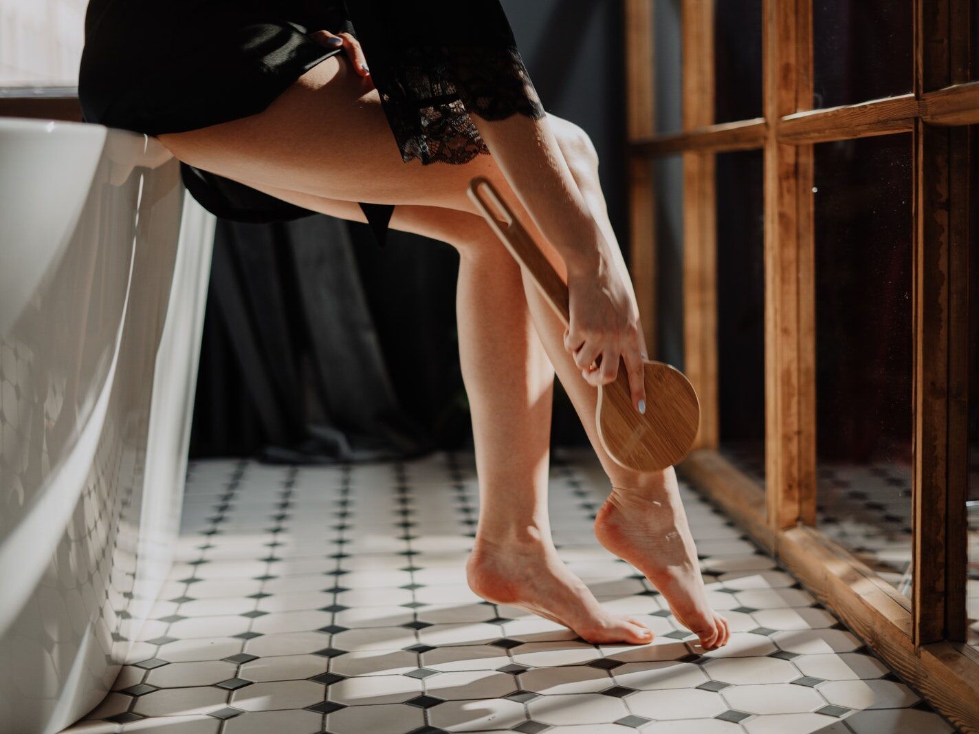 Woman in Black Skirt and White Shirt Kneeling on Floor