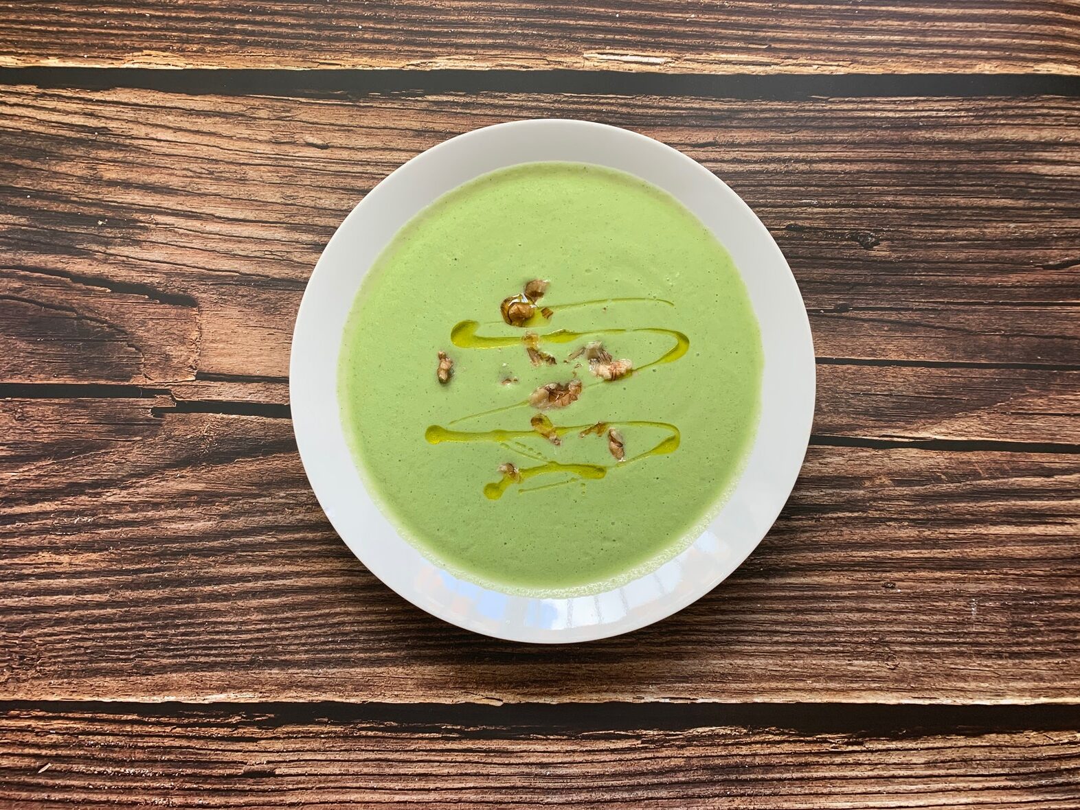 Delicious broccoli cream soup served in bowl