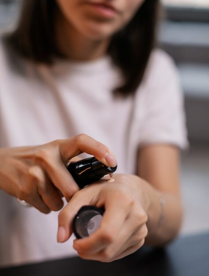 Woman in White Crew Neck T-shirt Holding Black Smartphone