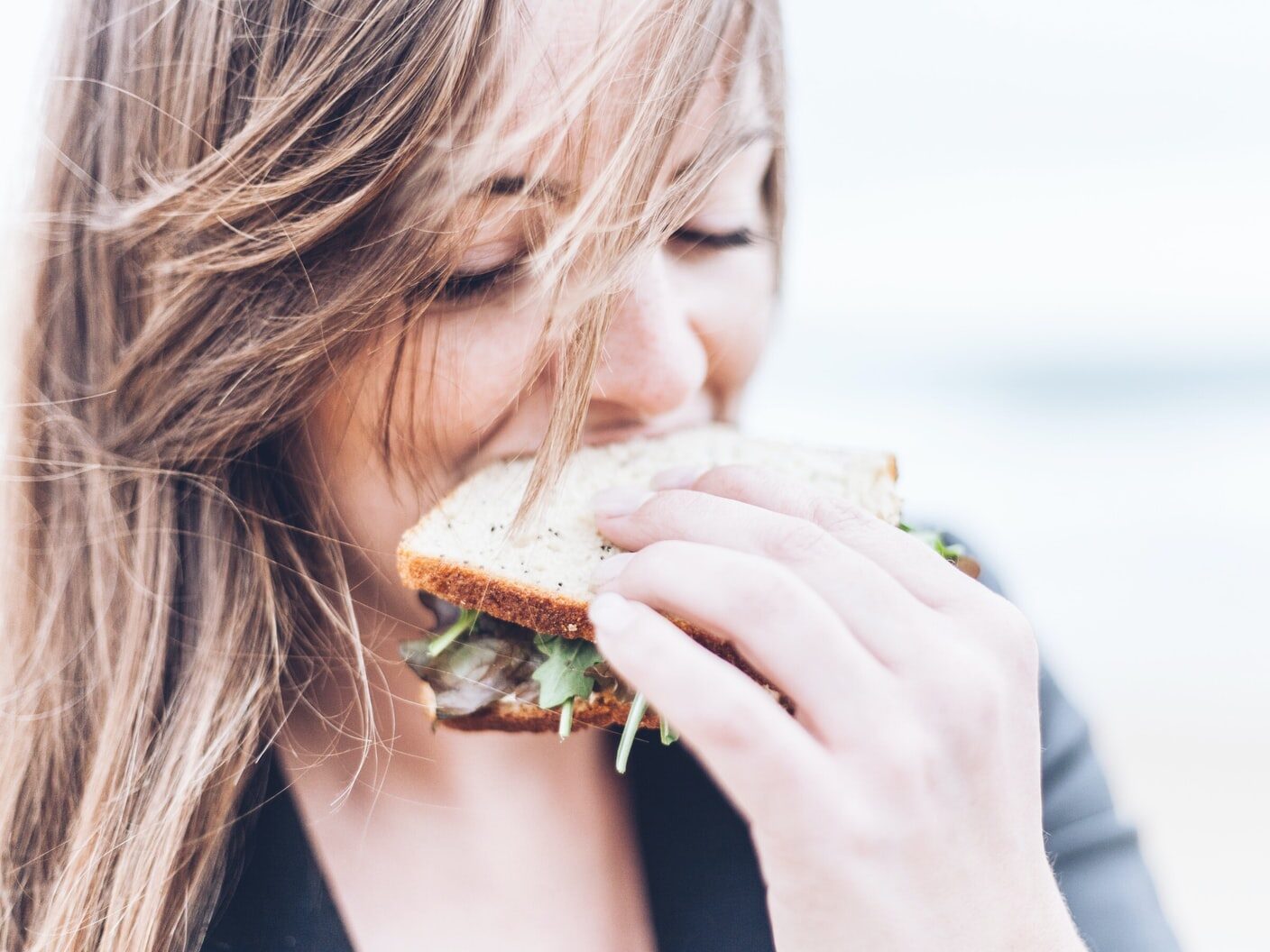 woman eating sandwich