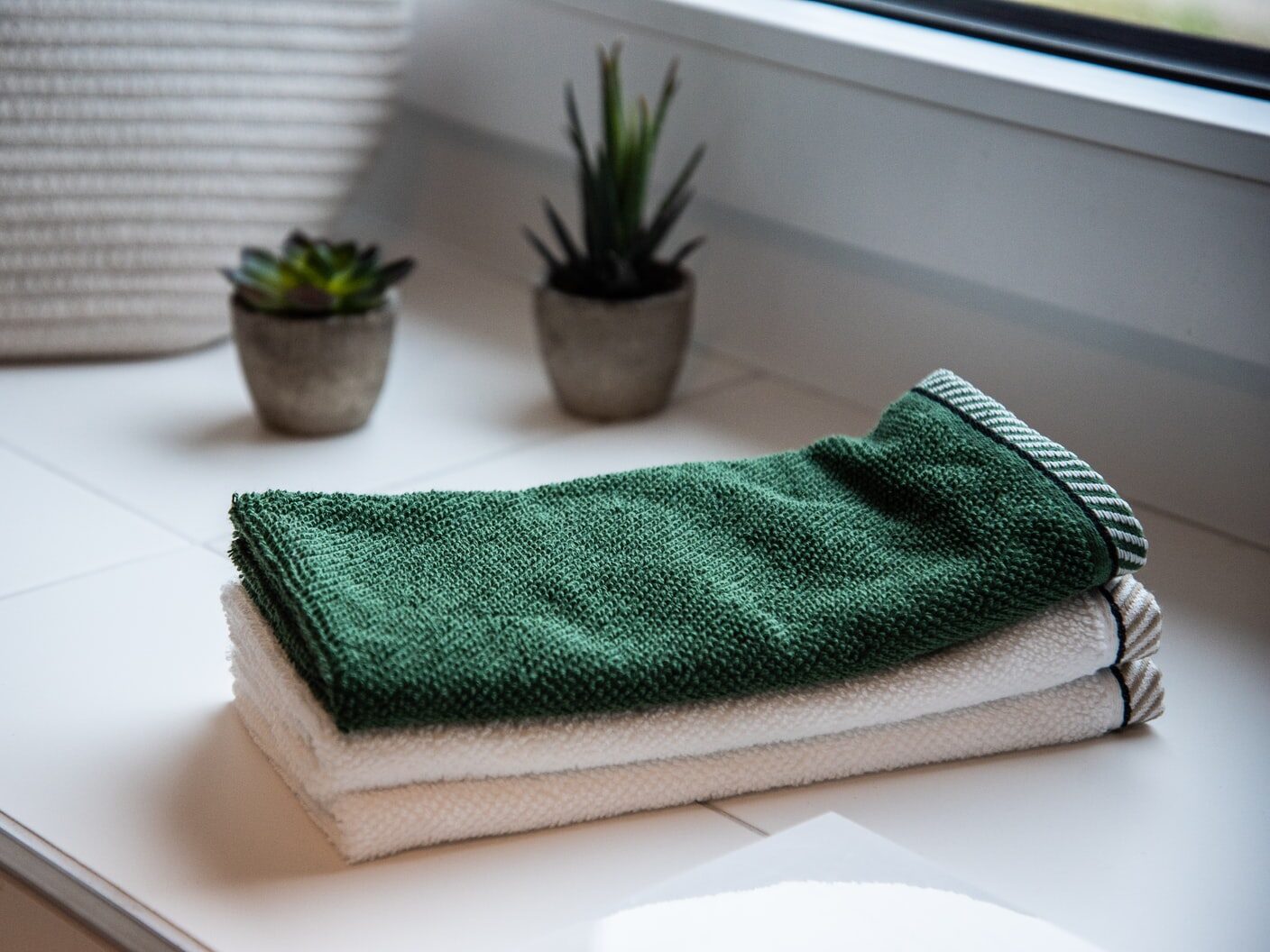 folded towels near potted plants