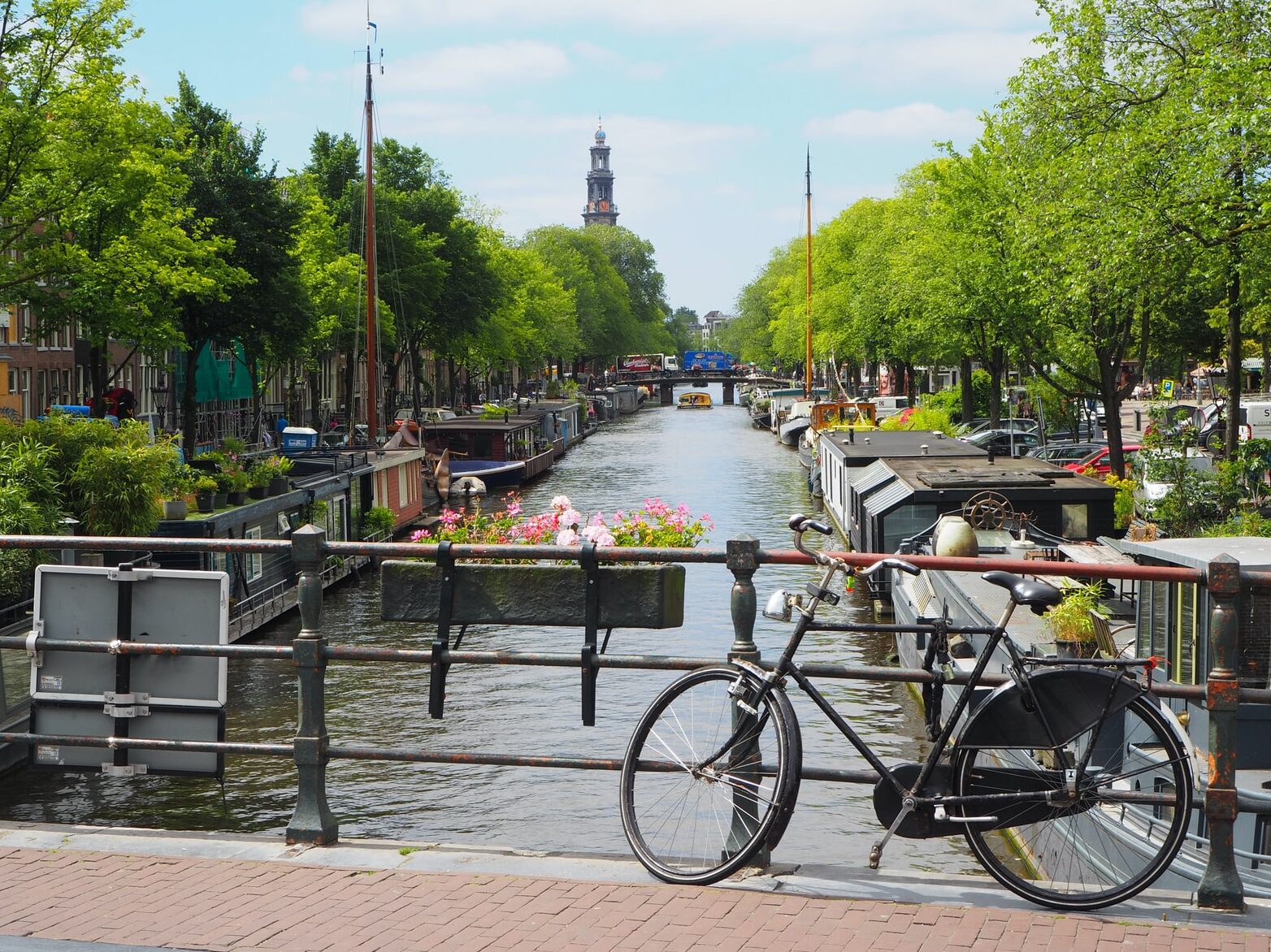 black city bike parked beside river during daytime