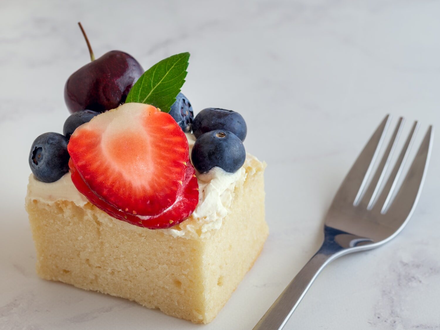 sliced cake with strawberry on top