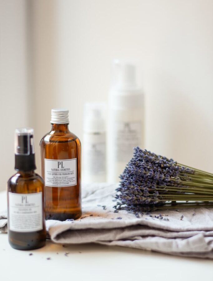 lavender flower beside oil bottle